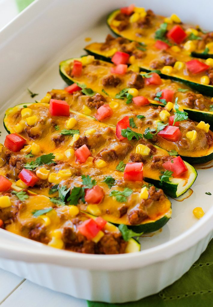 Beef enchilada zucchini boats are full of seasoned ground beef, homemade enchilada sauce and a couple veggies that are stuffed on top of zucchini. Life-in-the-Lofthouse.com