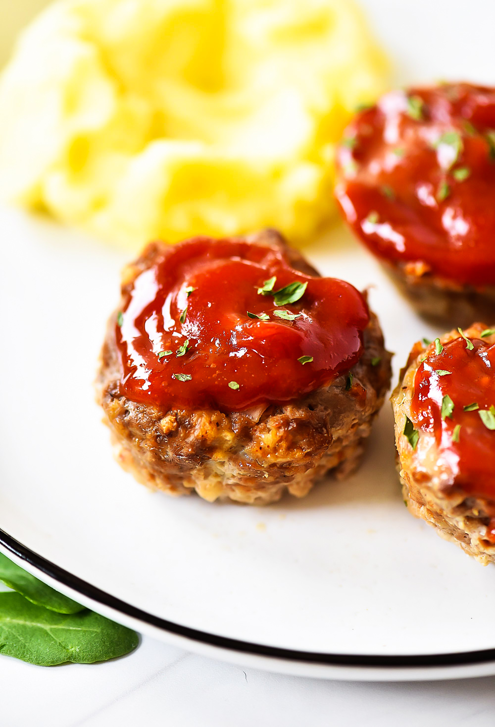 Mini Meatloaf Cups made with ground beef, cottage cheese, breadcrumbs and more. Topped with ketchup.