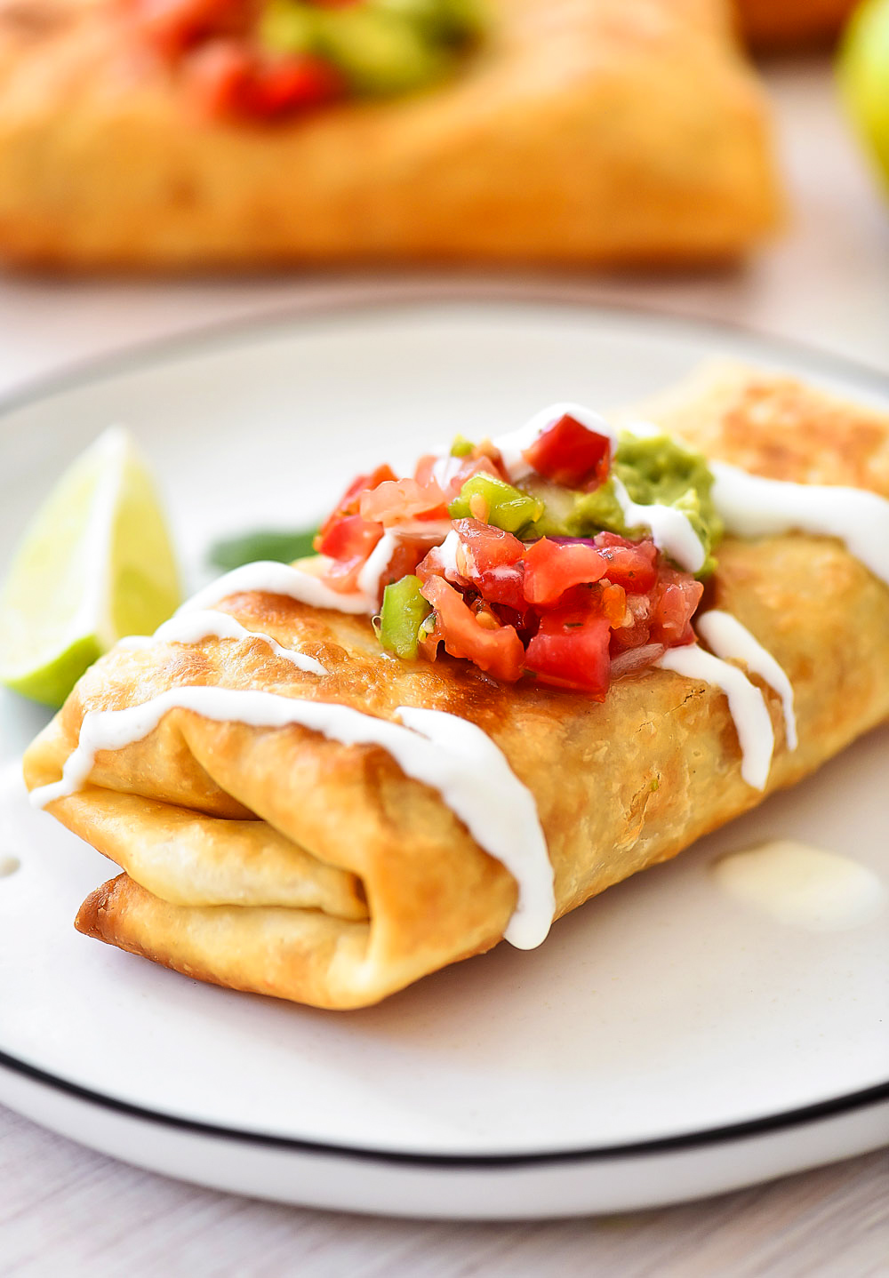 Chicken Chimichangas are filled with flavorful shredded chicken, Monterey jack cheese and diced green chilies. Life-in-the-Lofthouse.com