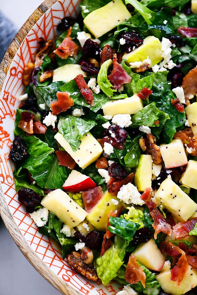 Autumn chopped salad is filled with chopped leafy greens, apples, cranberries, bacon, pecans and feta cheese. Life-in-the-Lofthouse.com