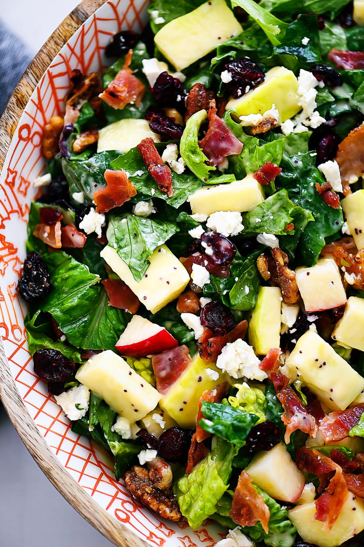 Autumn chopped salad is filled with chopped leafy greens, apples, cranberries, bacon, pecans and feta cheese. Life-in-the-Lofthouse.com