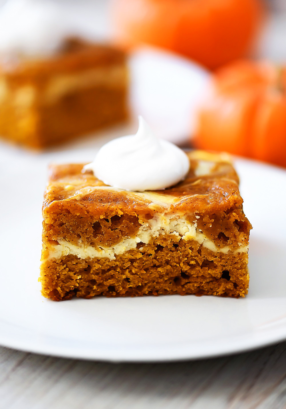 Pumpkin Roll Cake has layers of spice pumpkin cake with a cream cheese filling.