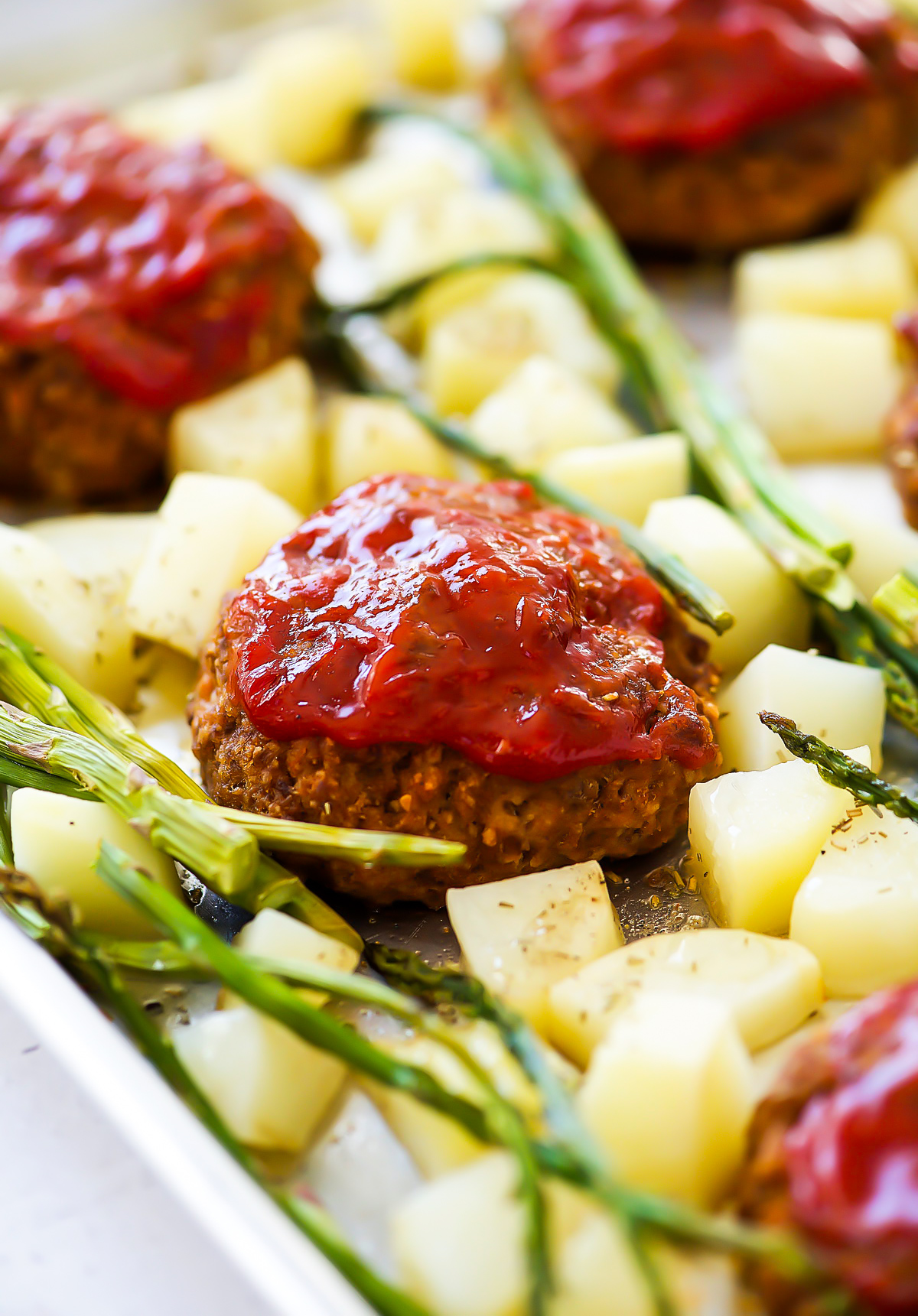 Sheet Pan Meatloaf dinner is individual mini meatloaves, asparagus, and potatoes all cooked to perfection on one pan.