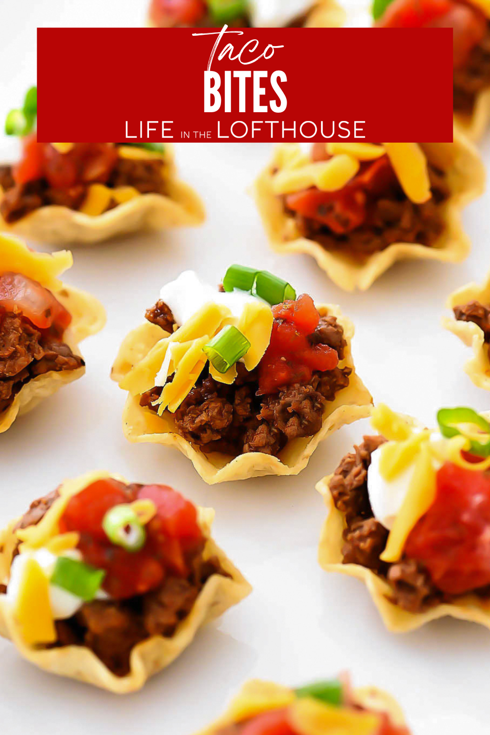 Mini Taco Bites with taco meat, cheese, sour cream, tomatoes, and more in a tortilla chip