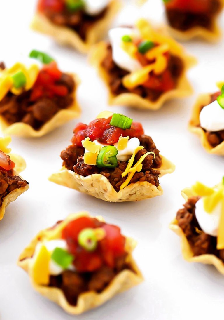 Taco Bites are small tortilla chips topped with taco meat and toppings.
