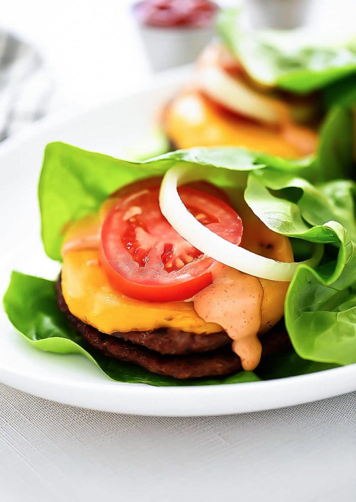 A flavorful burger topped with cheese, tomato, and a mouth-watering spread wrapped in lettuce. Life-in-the-Lofthouse.com