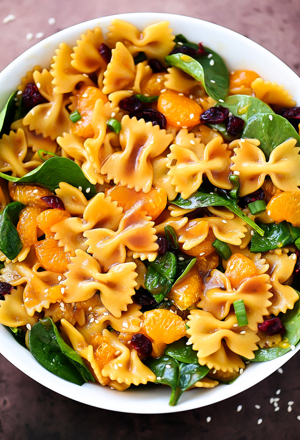 Mandarin Orange and Spinach Pasta Salad is bow tie pasta noodles coated in teriyaki sauce with oranges, spinach and dried cranberries. Life-in-the-Lofthouse.com