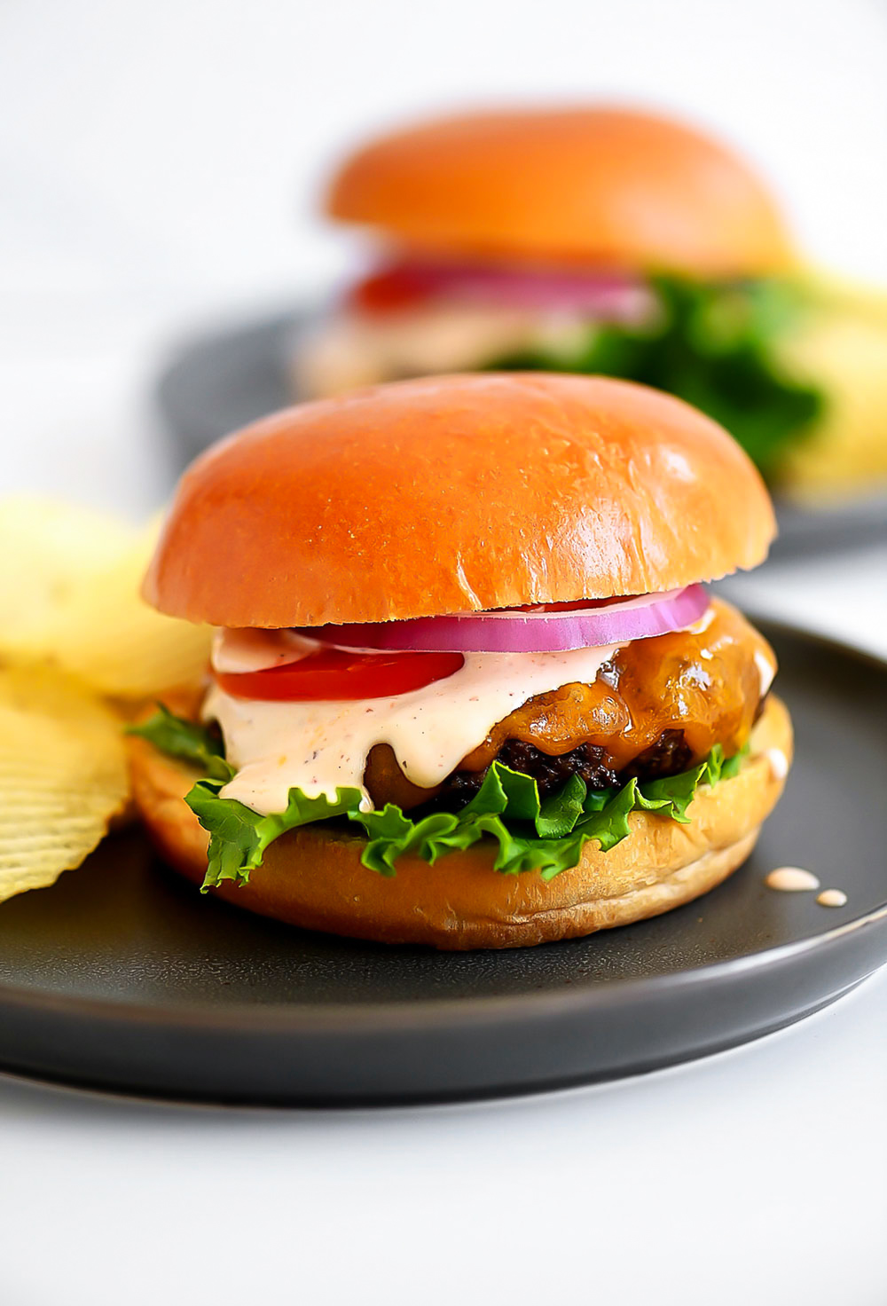 Chipotle Ranch Burgers are juicy burgers fresh off the grill smothered in chipotle ranch dressing, cheese, lettuce and tomato. Life-in-the-Lofthouse.com