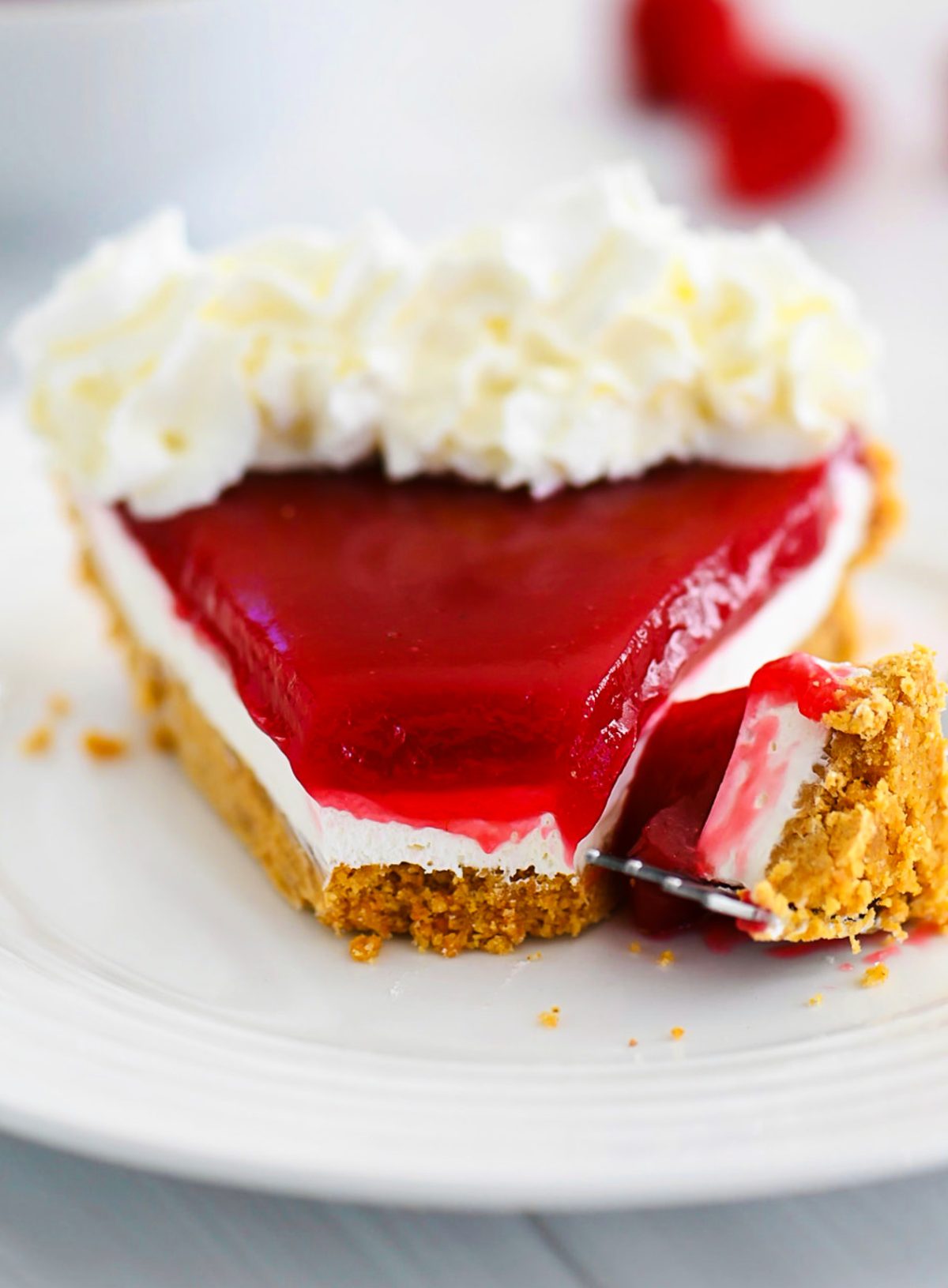 Raspberry Cream Pie has a graham cracker crust, cream cheese filling and raspberry topping!