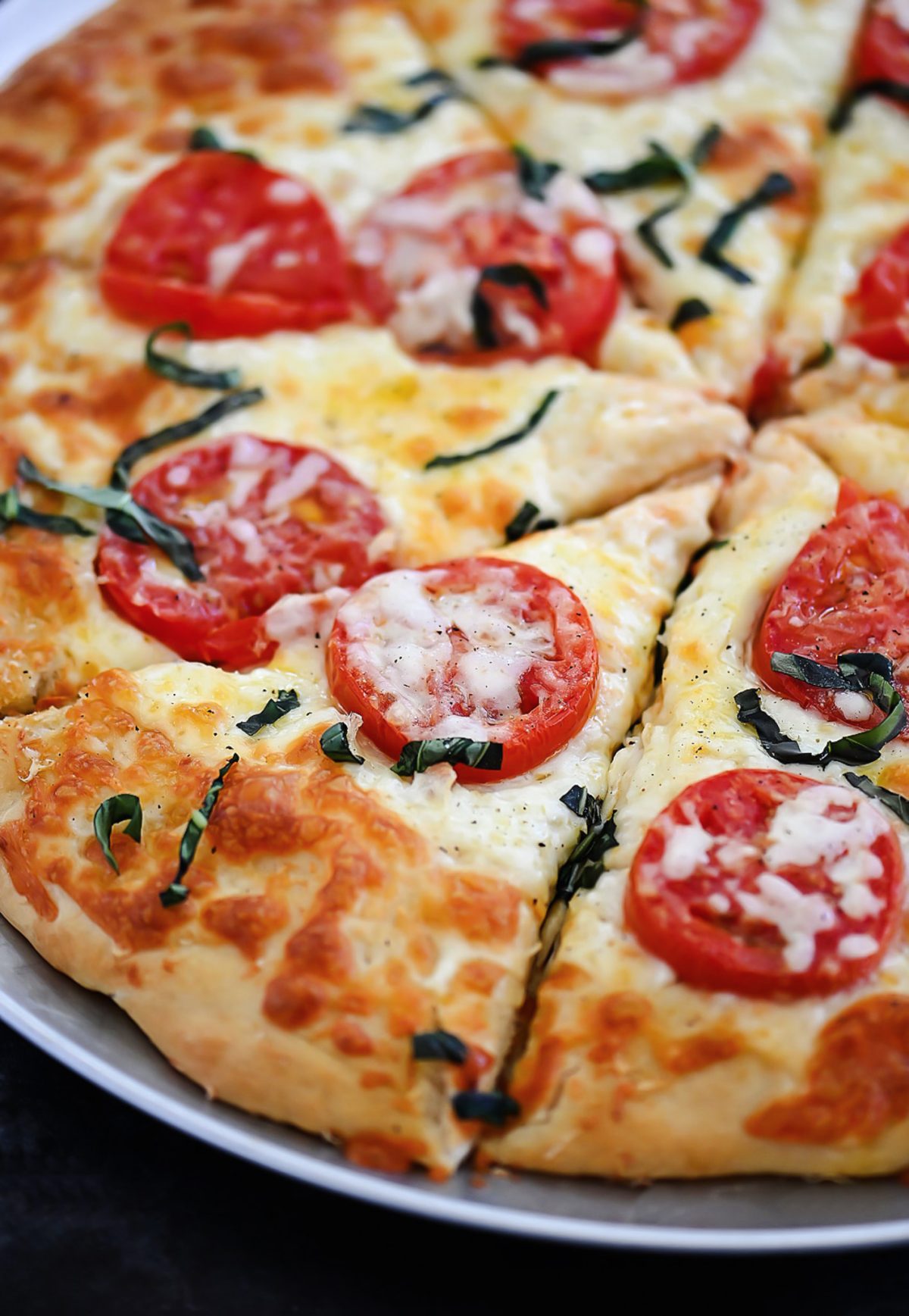 Margherita Pizza is topped with Mozzarella and Parmesan cheese, sliced tomatoes and fresh basil over pizza crust. Life-in-the-Lofthouse.com
