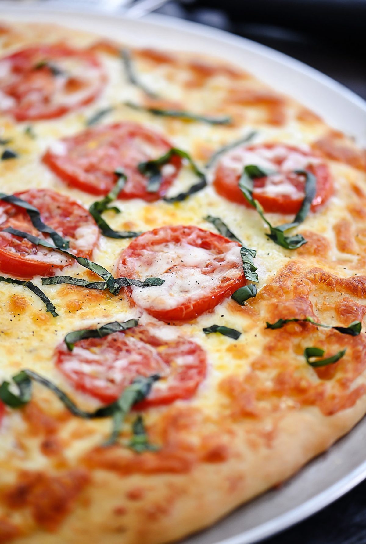 Margherita Pizza is topped with Mozzarella and Parmesan cheese, sliced tomatoes and fresh basil over pizza crust. Life-in-the-Lofthouse.com