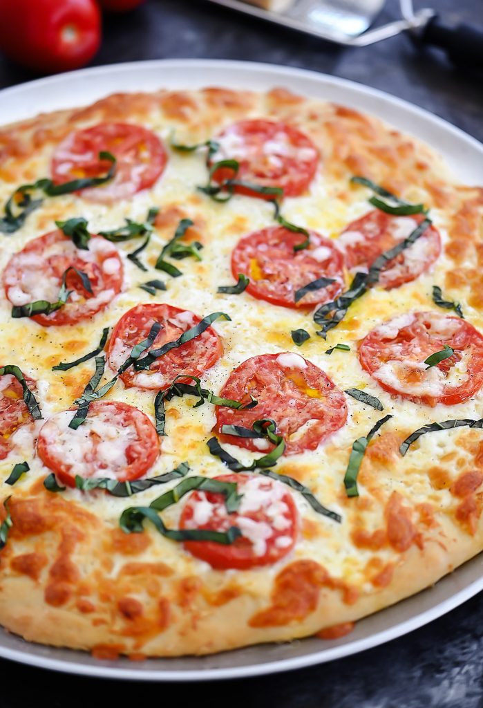 Margherita Pizza is topped with Mozzarella and Parmesan cheese, sliced tomatoes and fresh basil over pizza crust. Life-in-the-Lofthouse.com