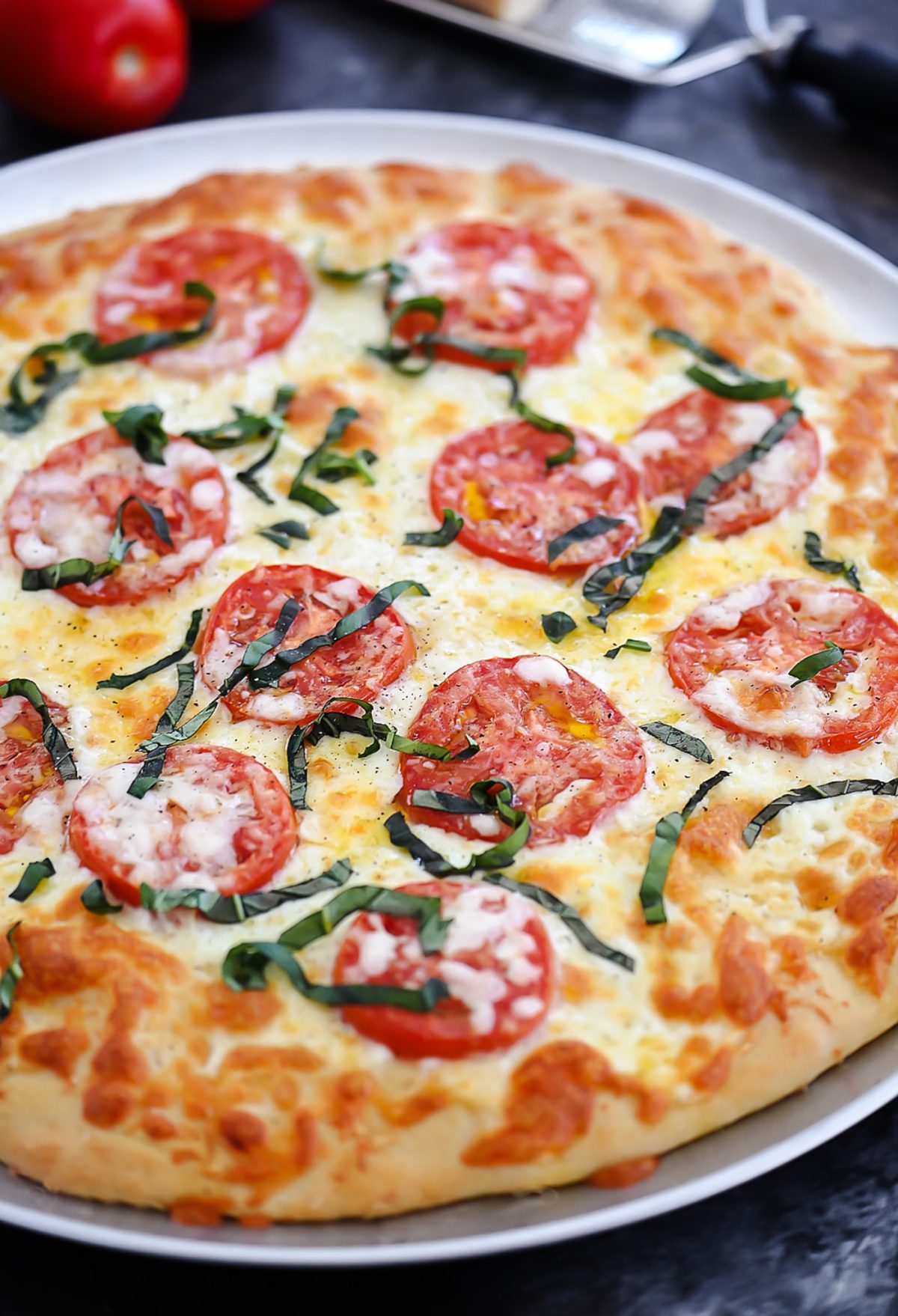 Margherita Pizza is topped with Mozzarella and Parmesan cheese, sliced tomatoes and fresh basil over pizza crust. Life-in-the-Lofthouse.com