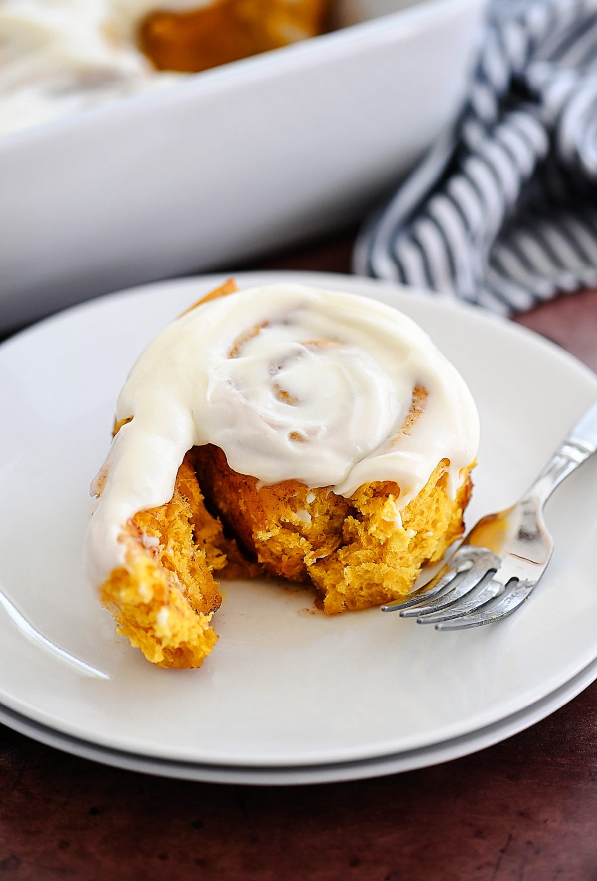Pumpkin Cinnamon Rolls are soft, delicious cinnamon rolls full of pumpkin flavor and topped with a vanilla and pumpkin flavored icing. Life-in-the-Lofthouse.com