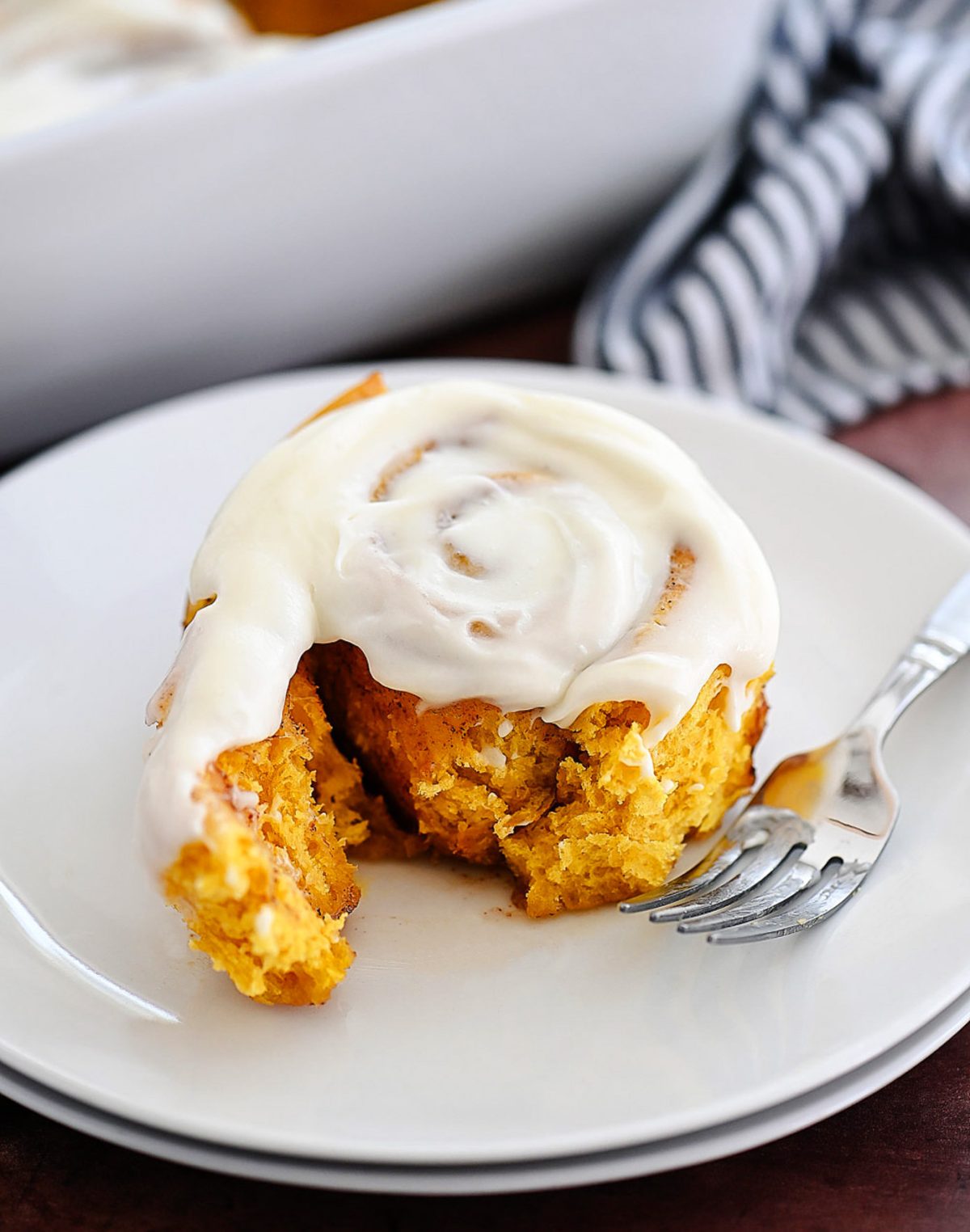 Pumpkin Cinnamon Rolls are soft, delicious cinnamon rolls full of pumpkin flavor and topped with a vanilla and pumpkin flavored icing. Life-in-the-Lofthouse.com