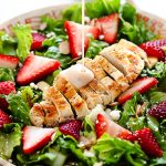Strawberry Chicken Salad is filled with chopped romaine lettuce, sprinkles of sliced almonds, sliced strawberries and grilled&nbsp;chicken.