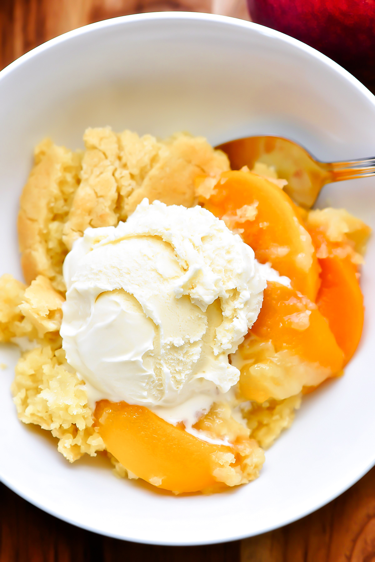 This Best Peach Cobbler is a delicious cake-like dessert made with sliced peaches and served warm with vanilla ice-cream. Life-in-the-Lofthouse.com