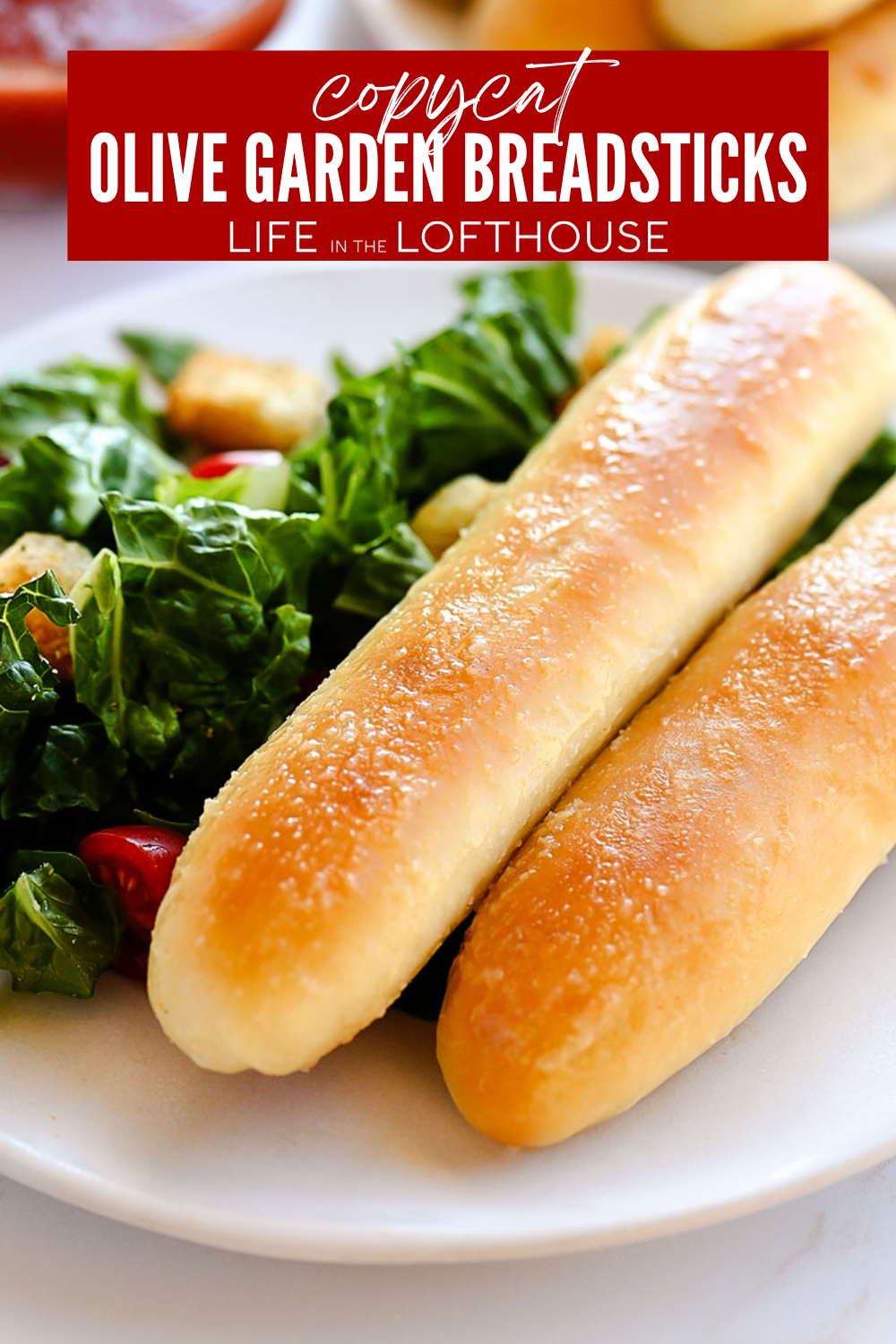 Copycat Olive Garden Breadsticks with side salad on a plate