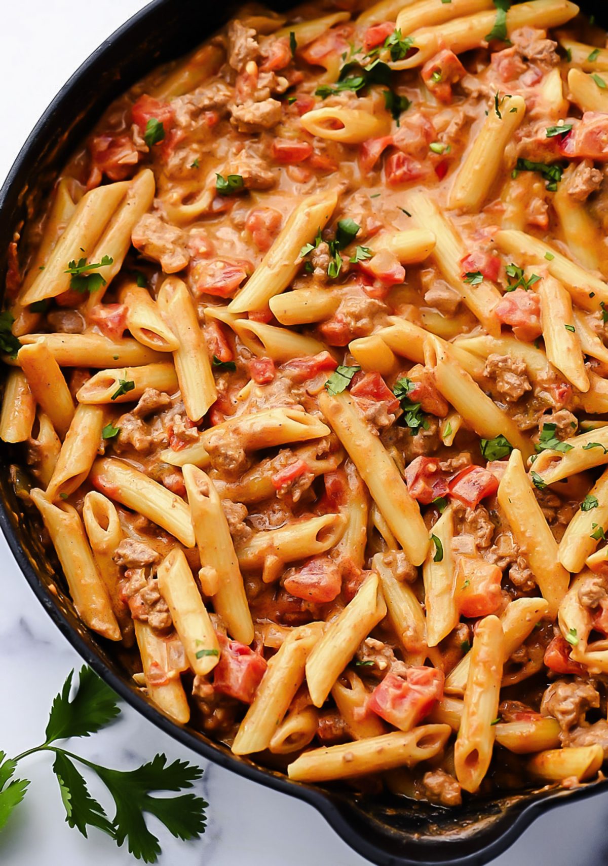 Creamy Tex-Mex pasta with ground beef, Rotel tomatoes, and melted cheese.