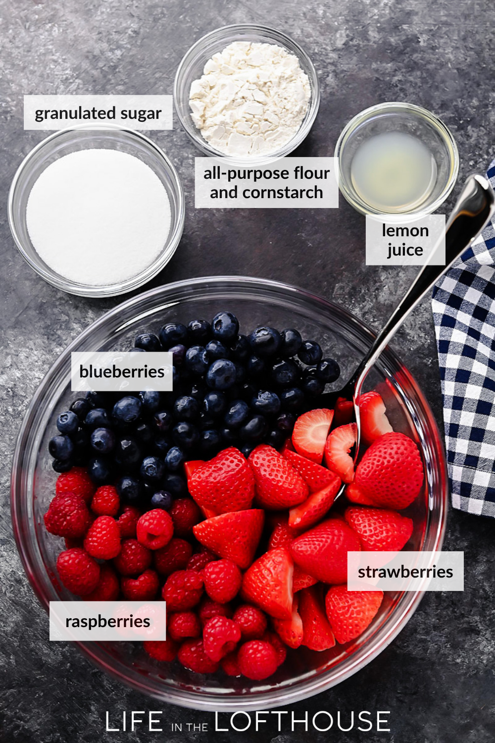 A warm berry crisp with bubbling mixed berries and a golden oat crumble topping, served in a white dish with a scoop of melting vanilla ice cream on top.