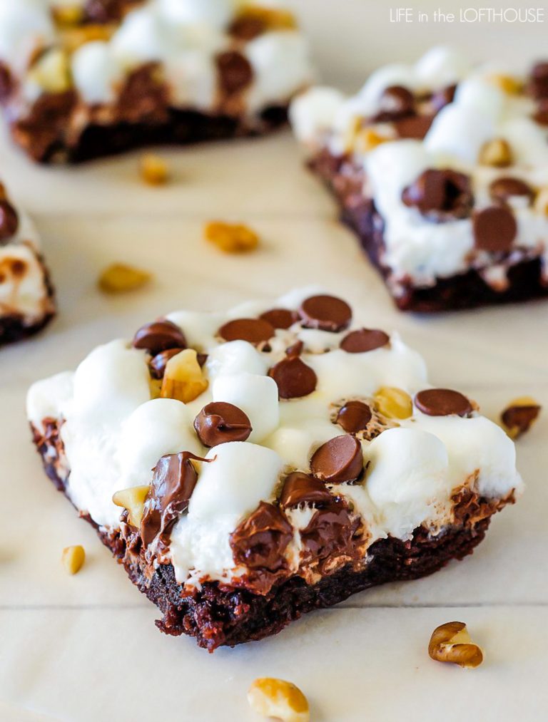Rocky road brownies are soft and delicious brownies covered in mini marshmallows, chocolate chips and chopped walnuts. Life-in-the-Lofthouse.com