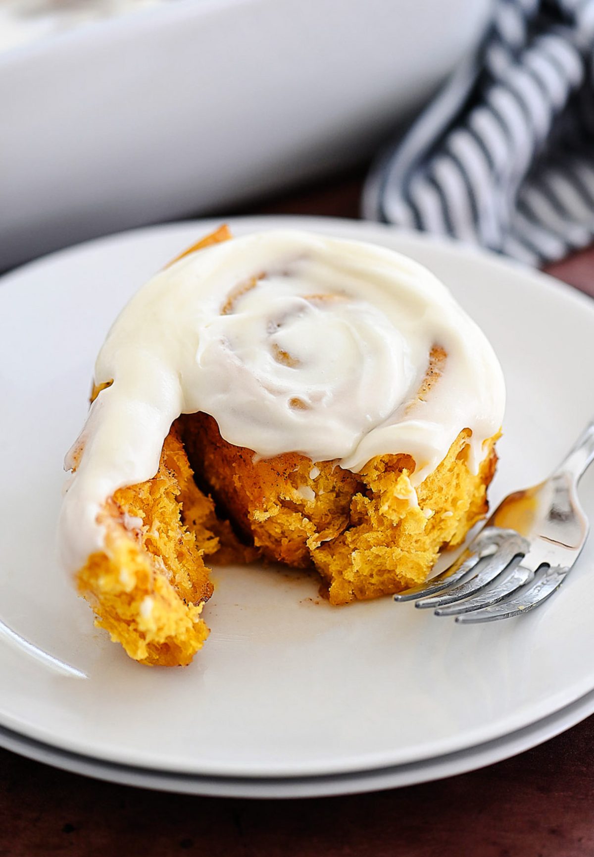 Pumpkin Cinnamon Rolls are soft, delicious cinnamon rolls full of pumpkin flavor and topped with a vanilla and pumpkin flavored icing. Life-in-the-Lofthouse.com