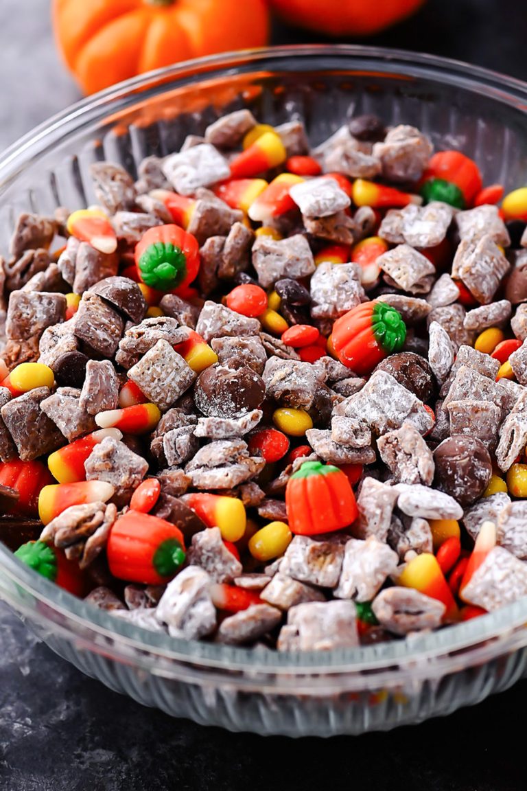 Halloween Muddy Buddies with rice Chex, chocolate, powdered sugar, and Halloween candy.